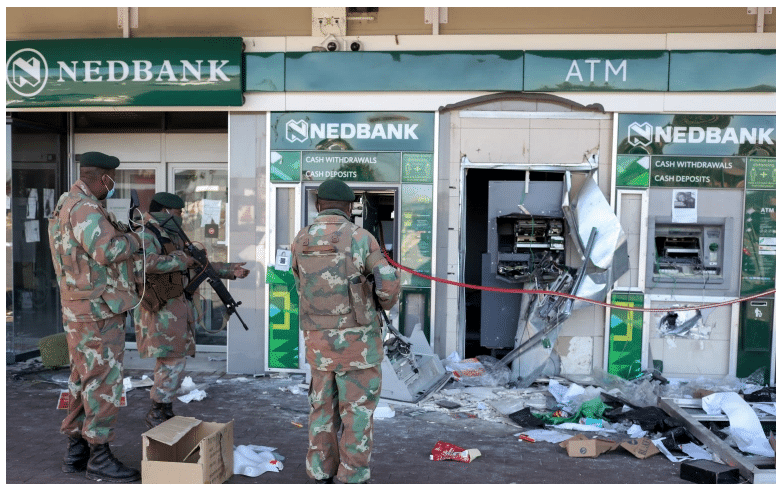 South African soldiers outside a damaged ATM